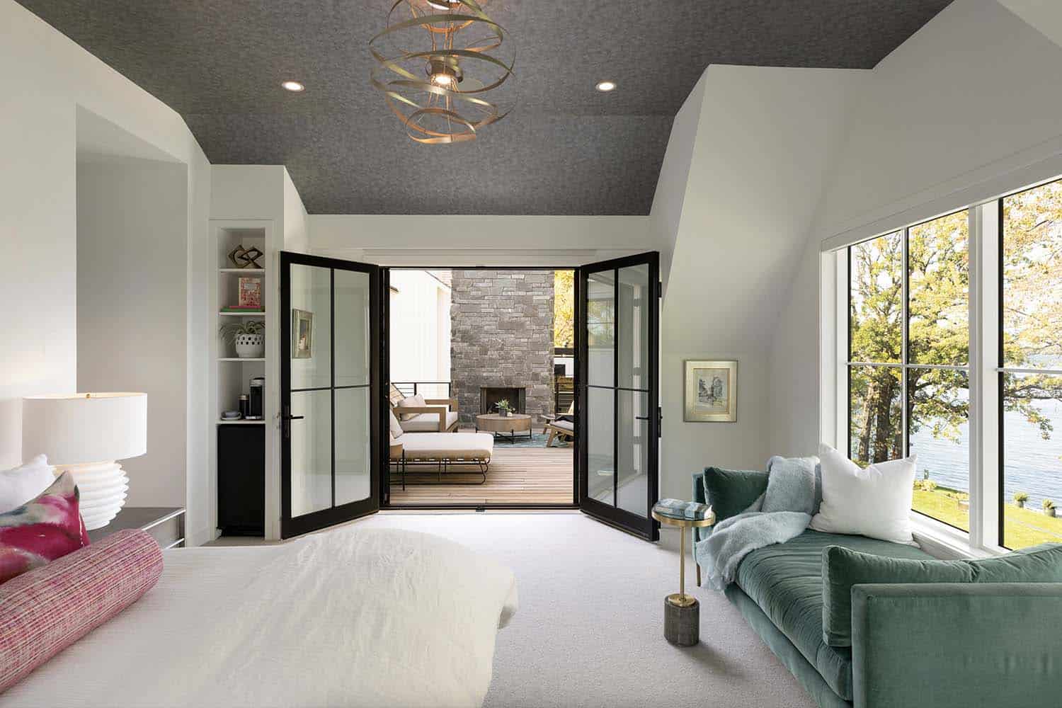 contemporary bedroom with folding doors leading out to a private patio