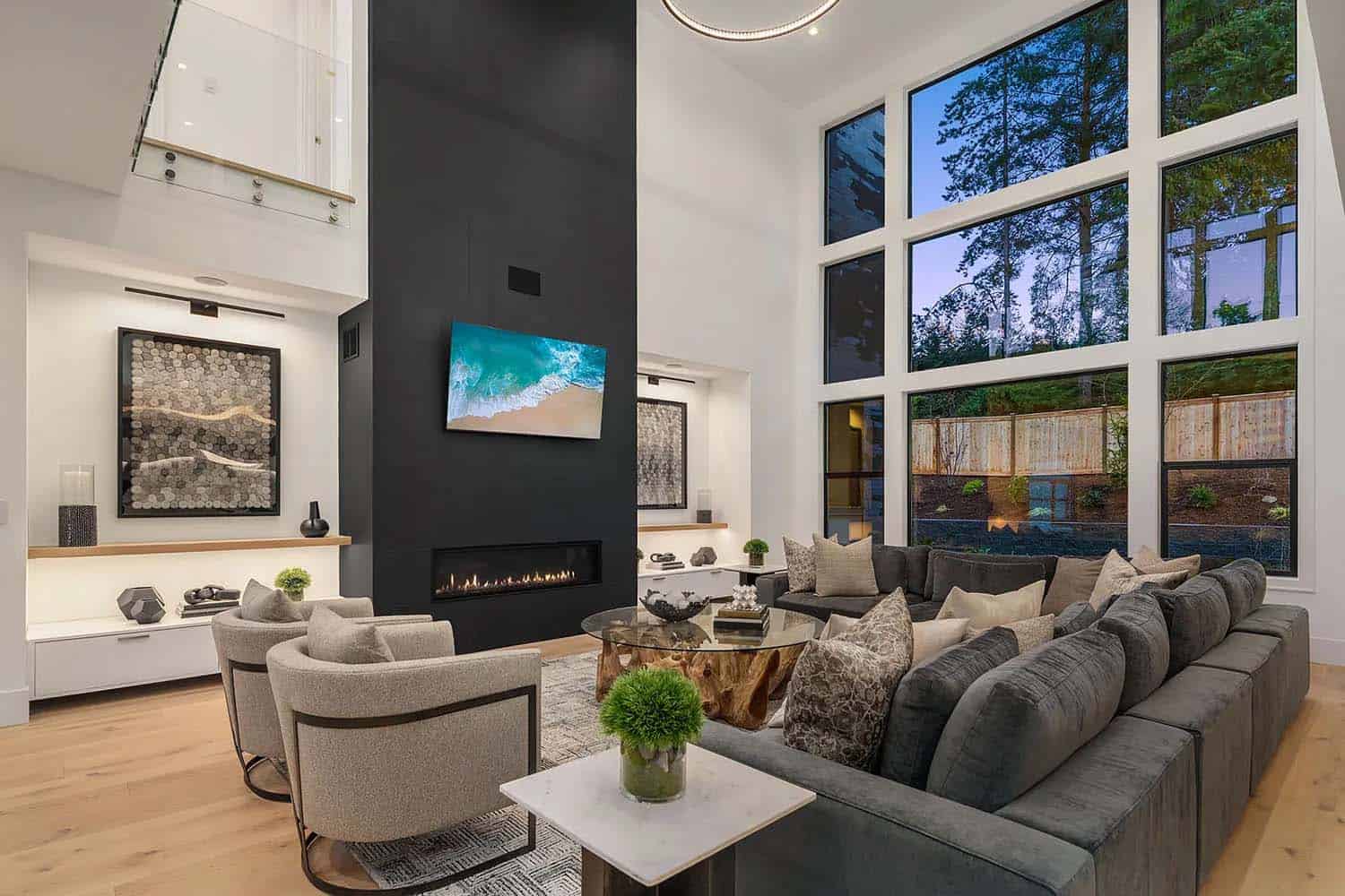 contemporary two-story living room with a fireplace
