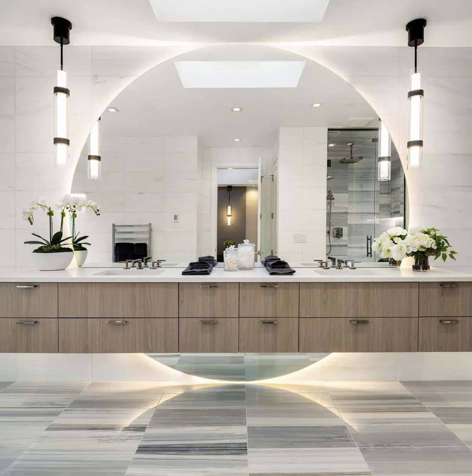 contemporary primary bathroom with a vanity and under-mount lighting