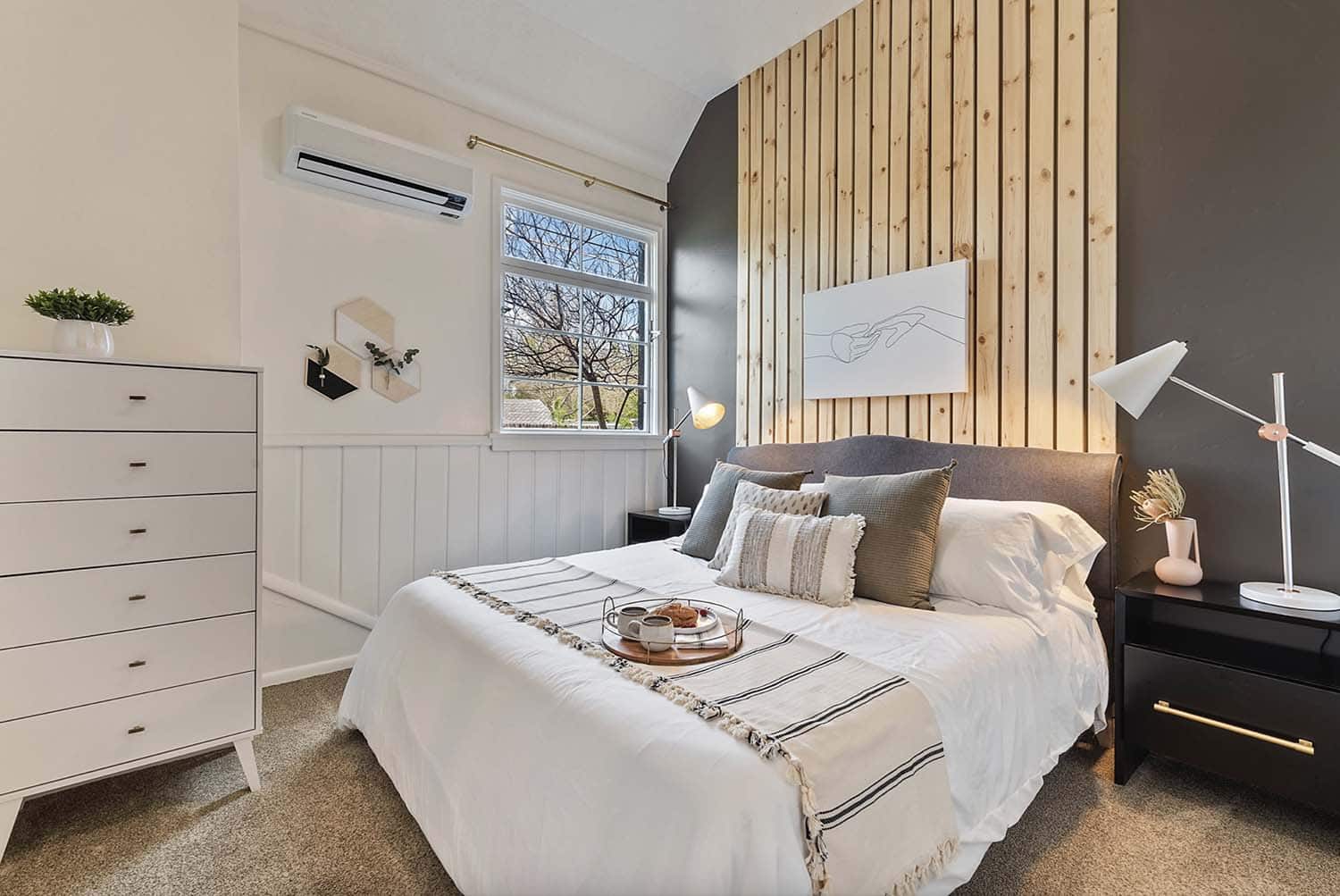 Scandinavian bedroom with a wood accent wall