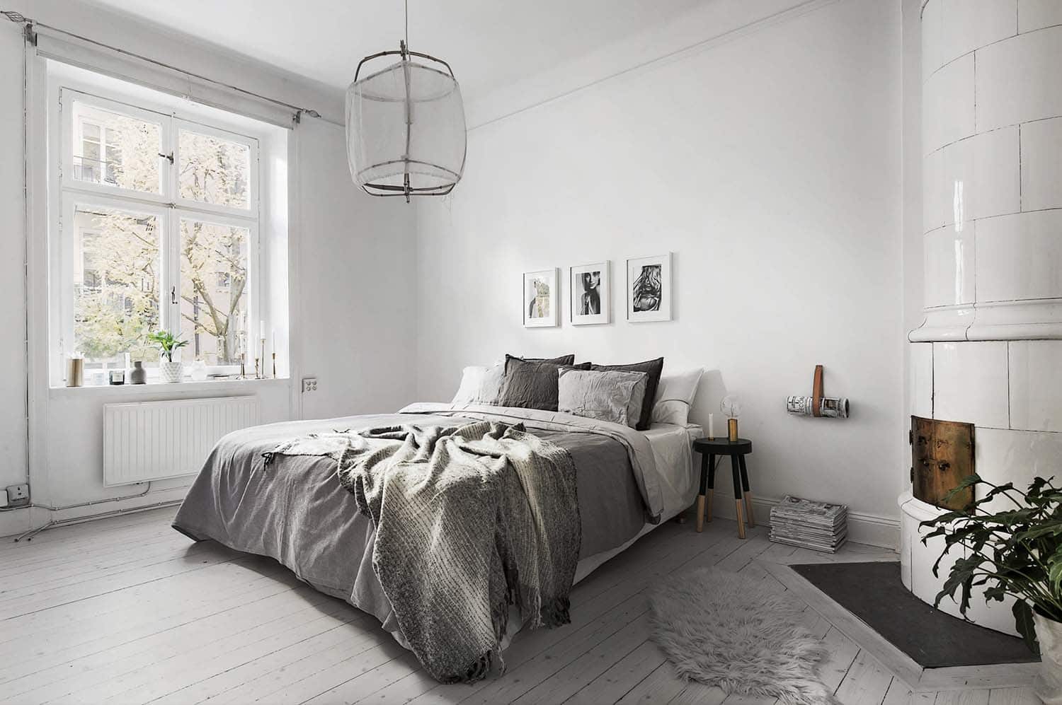 white Scandinavian bedroom with a fireplace