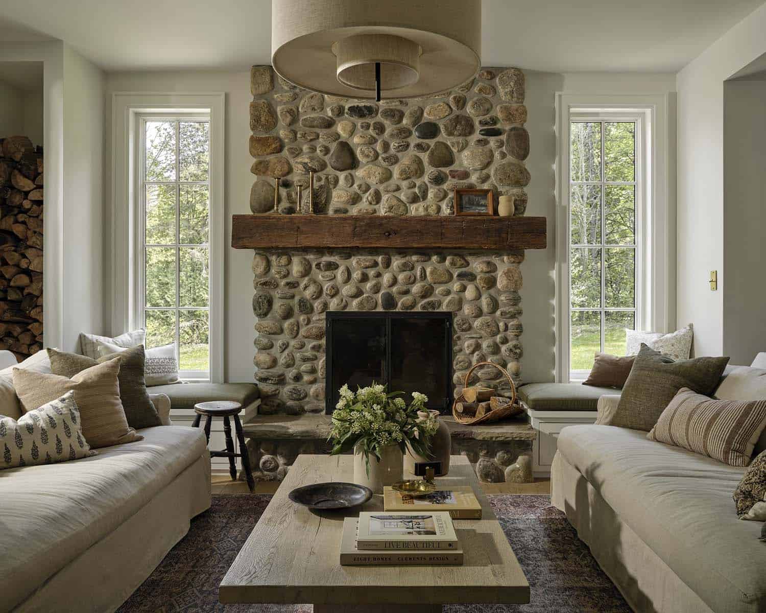 contemporary living room with a stone clad fireplace with window seats