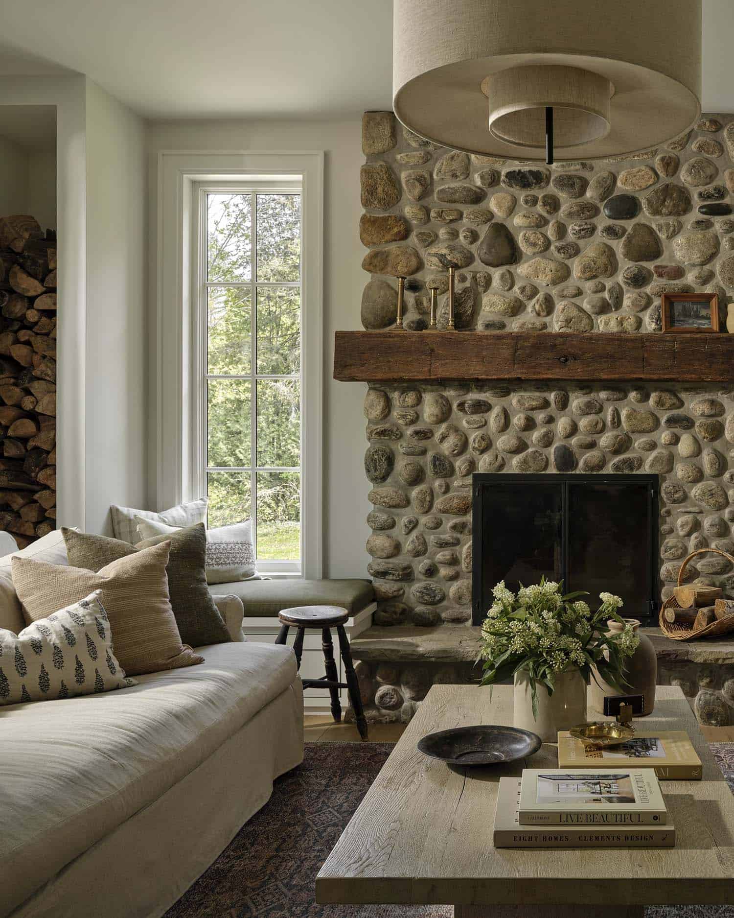 contemporary living room with a stone clad fireplace