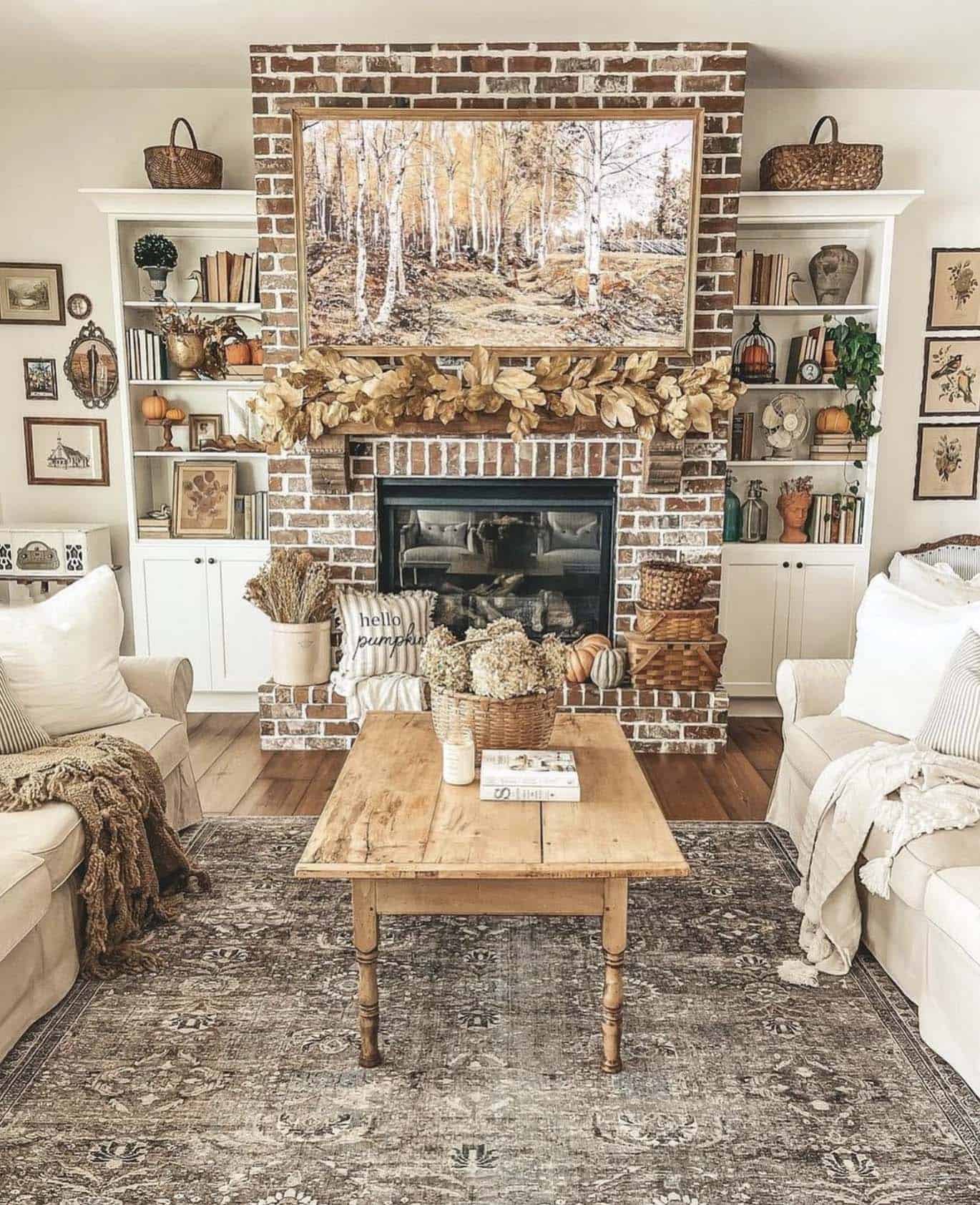 farmhouse living room with fall decor and wall art above the mantel