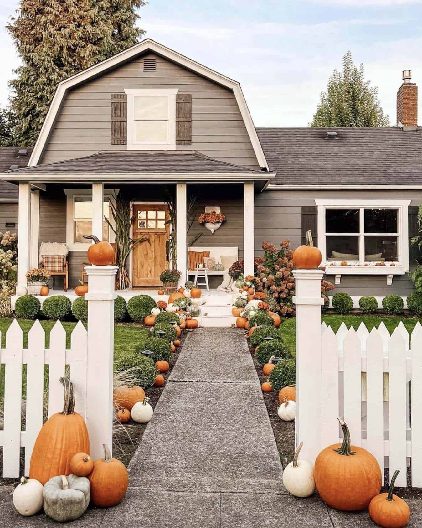 farmhouse home exterior with fall pumpkins