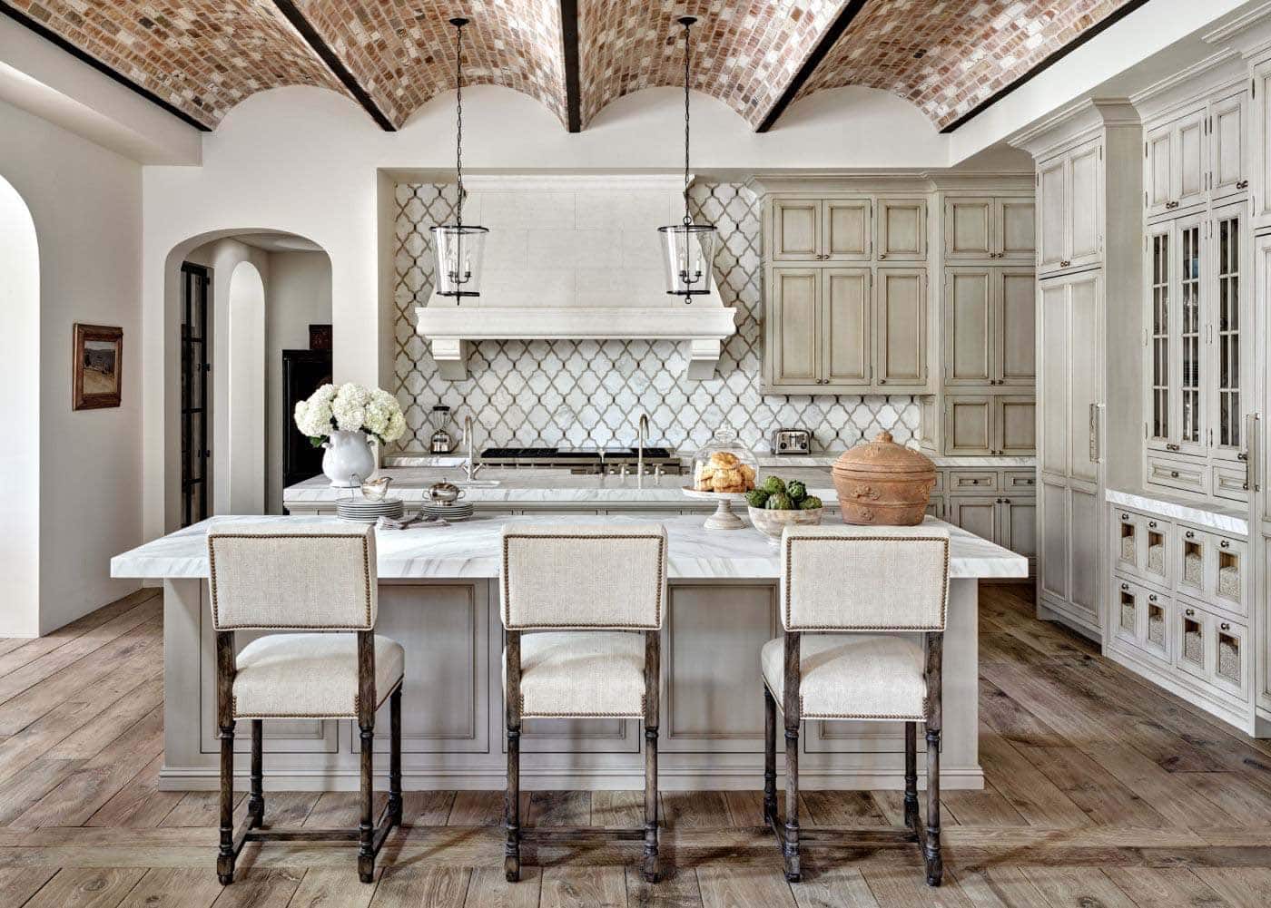 mediterranean style kitchen with an island and marble countertops