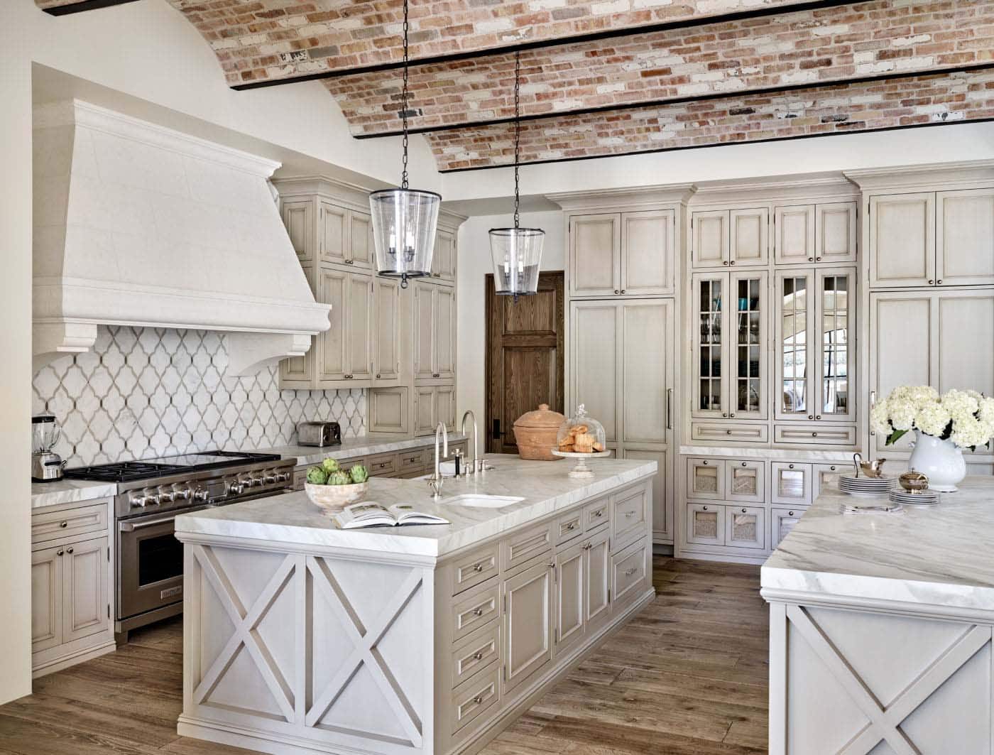 mediterranean style kitchen with an island and marble countertops