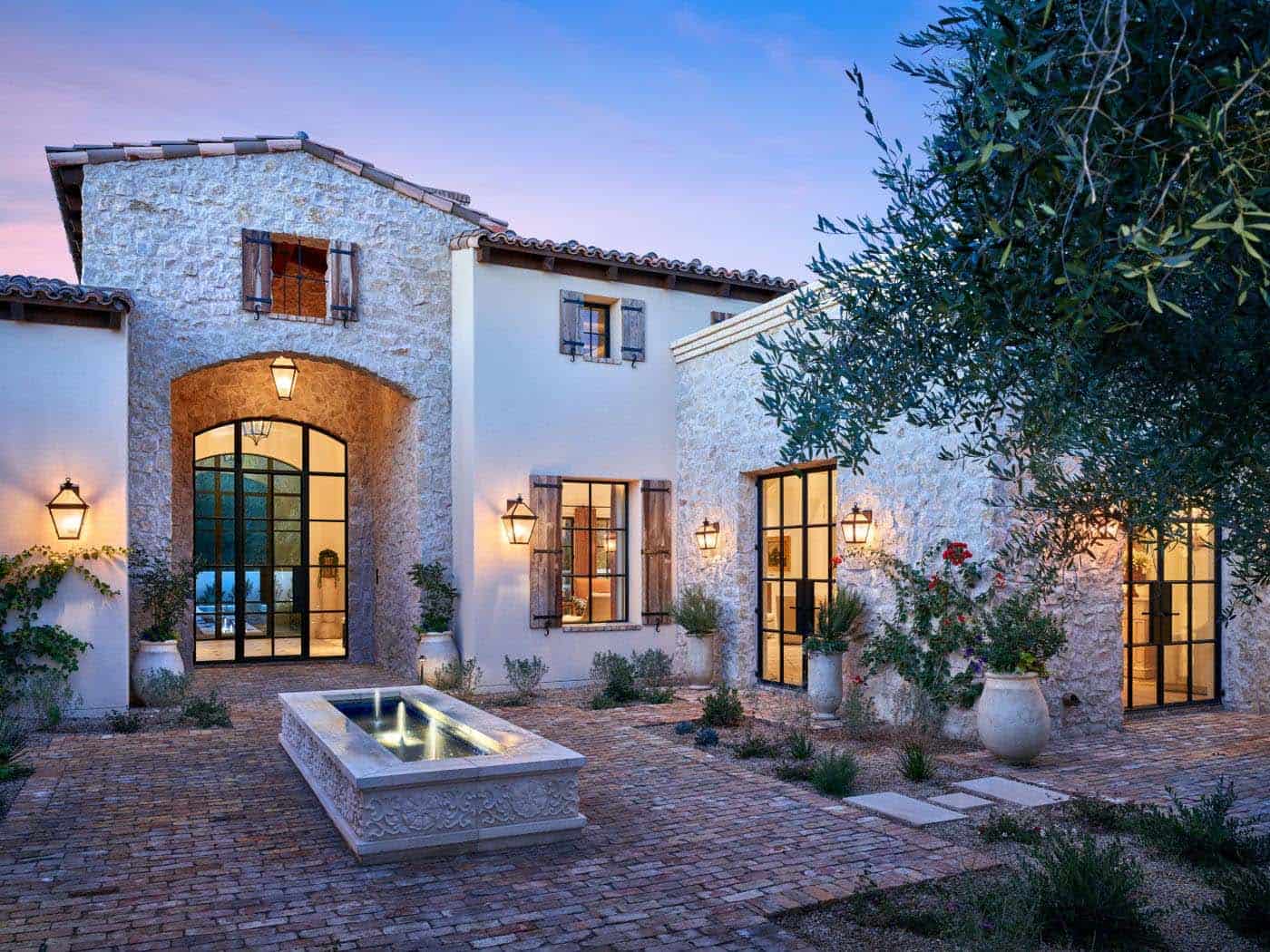 mediterranean villa with a courtyard and water feature