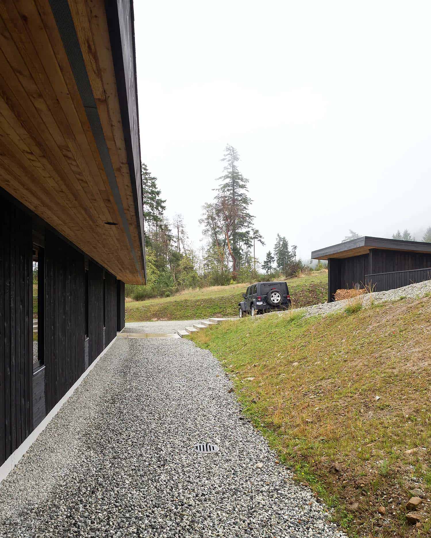 midcentury modern home exterior with a gravel stone pathway