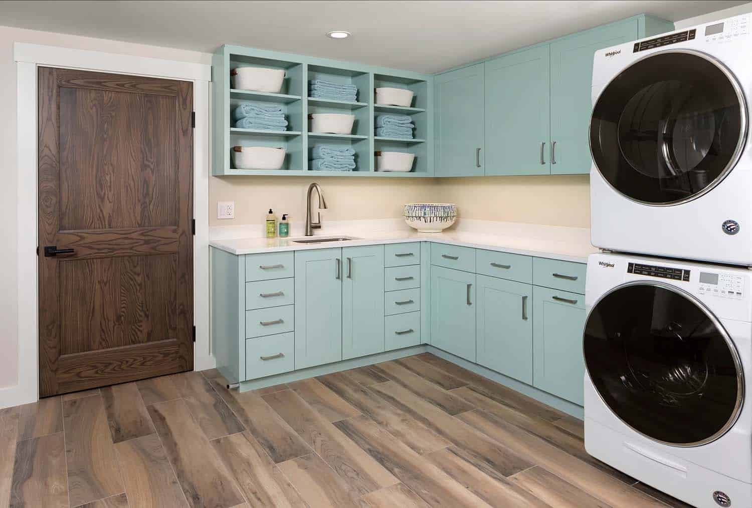 modern coastal laundry room with light blue cabinets
