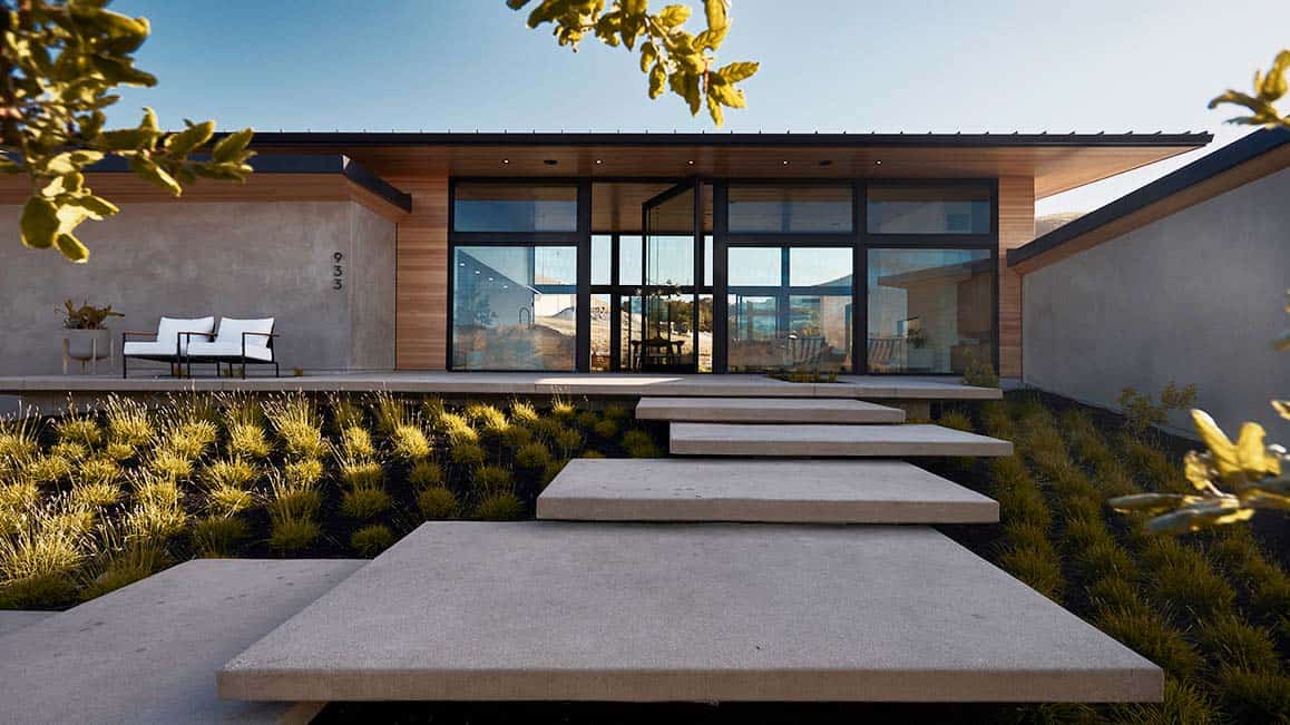 modern home exterior with pavers leading to the front door