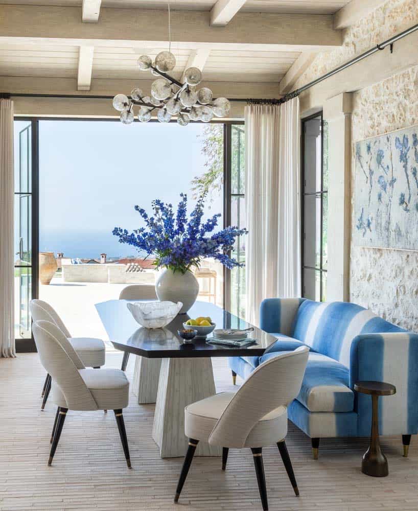 modern mediterranean dining room with a large window