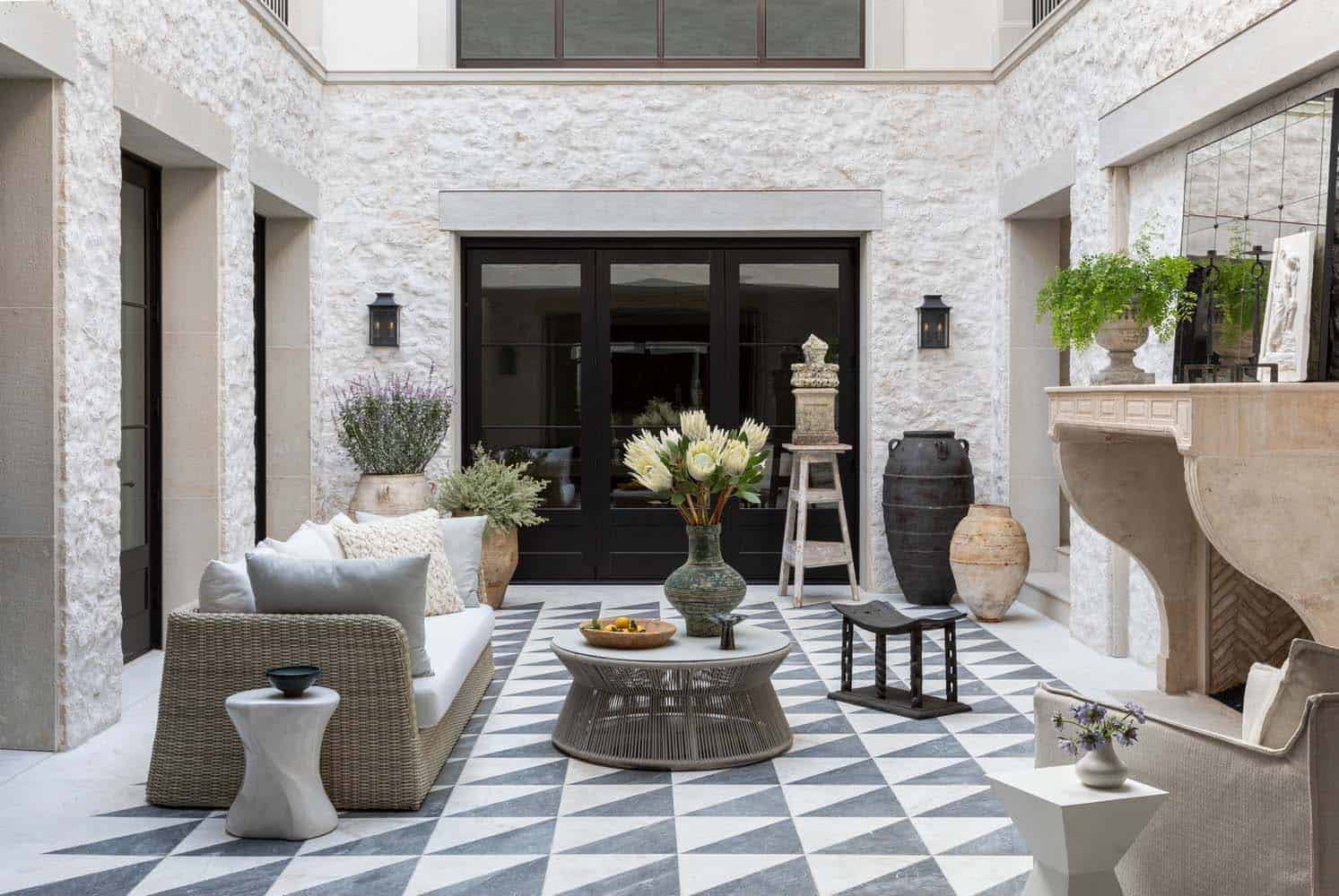 modern mediterranean courtyard with black and white tiles