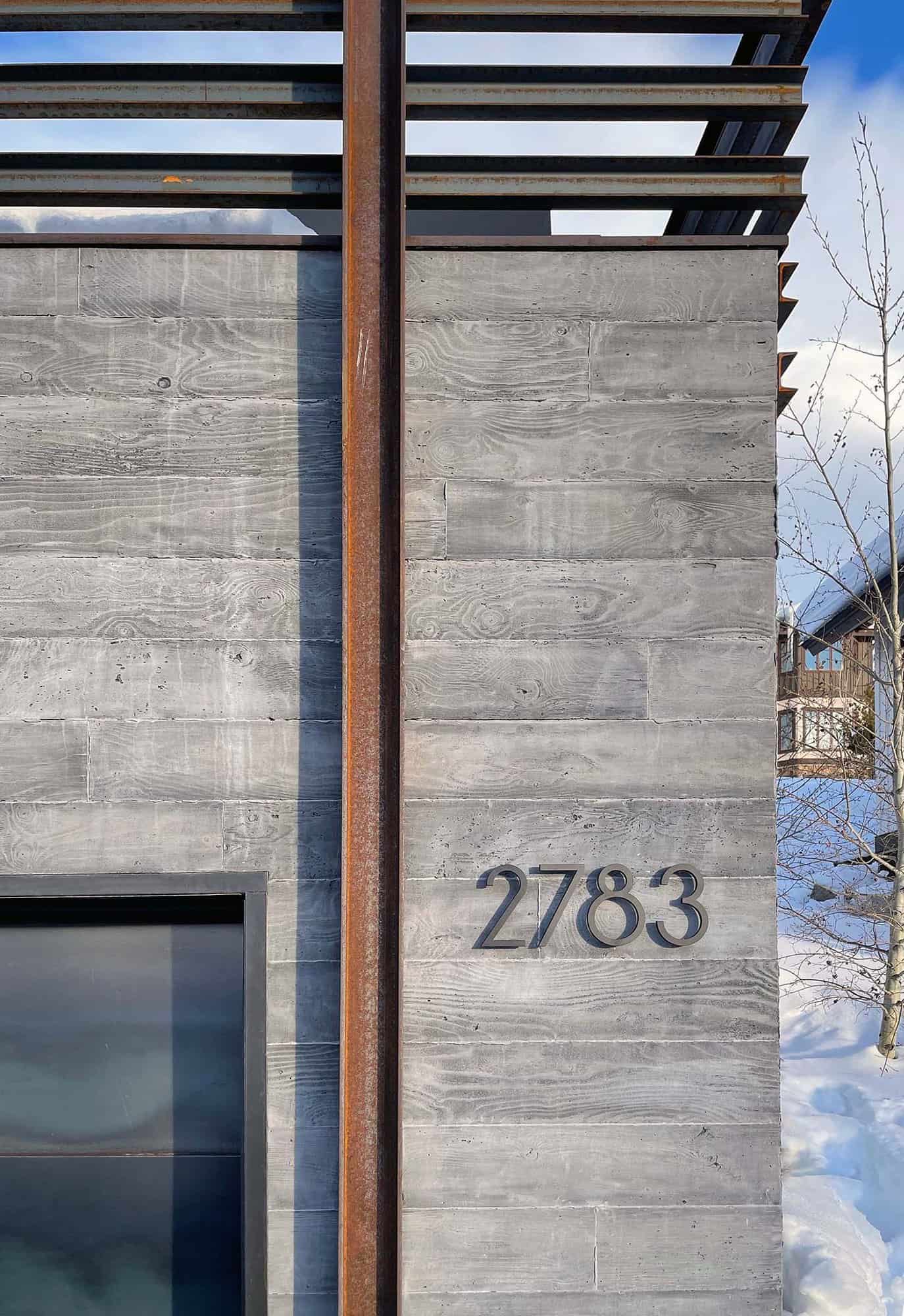 contemporary mountain home exterior wall with house numbers