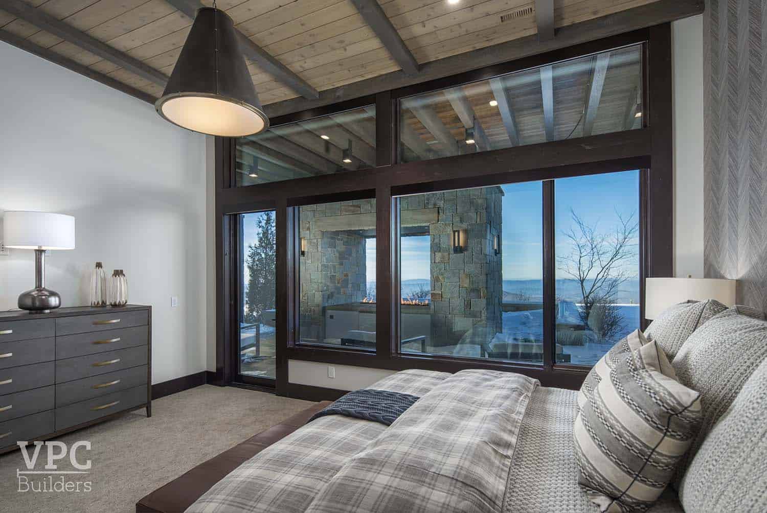 contemporary bedroom with sliding glass doors leading out to a patio