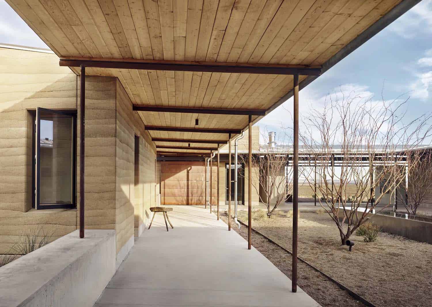 rammed earth ranch house covered entry