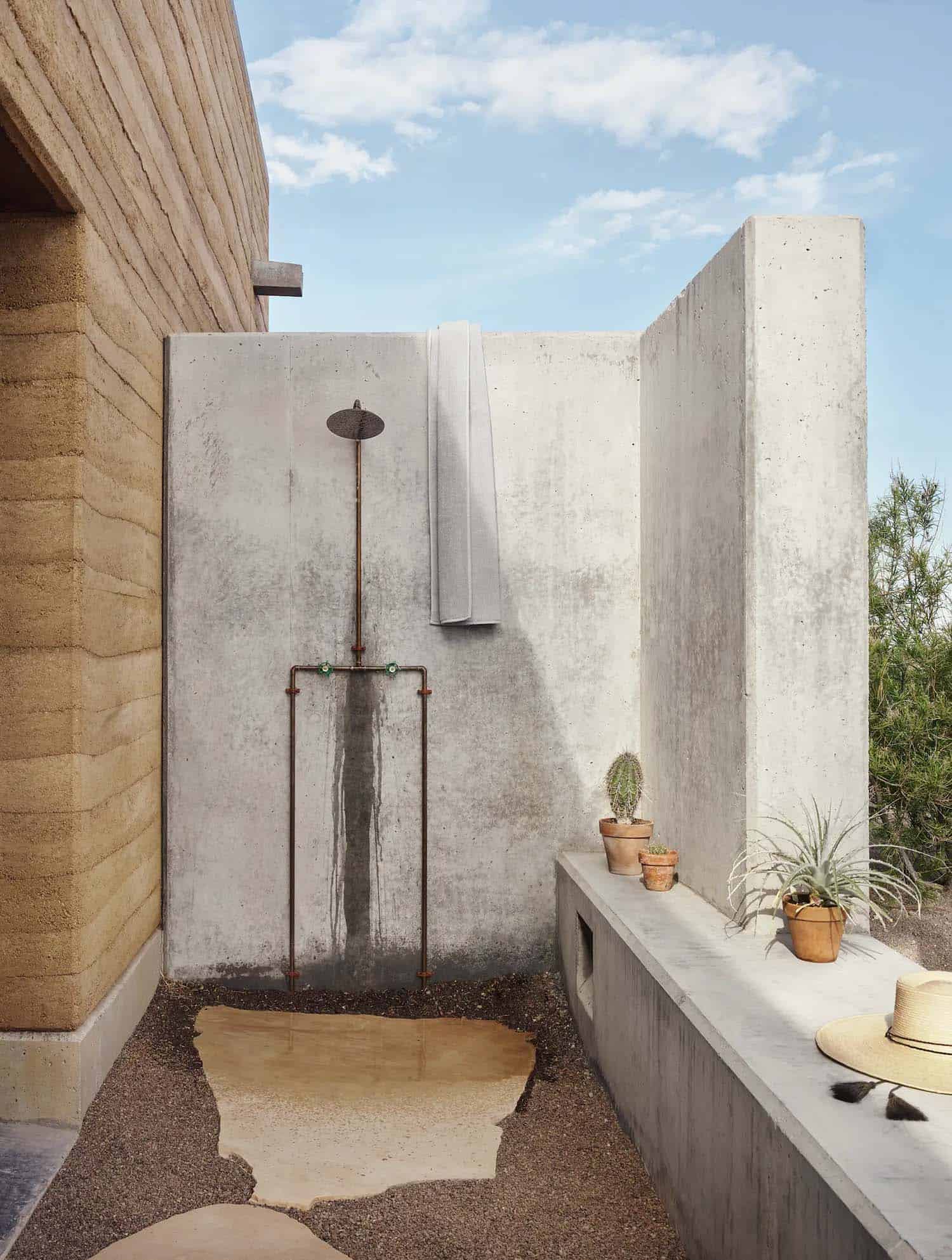 rammed earth ranch house outdoor shower