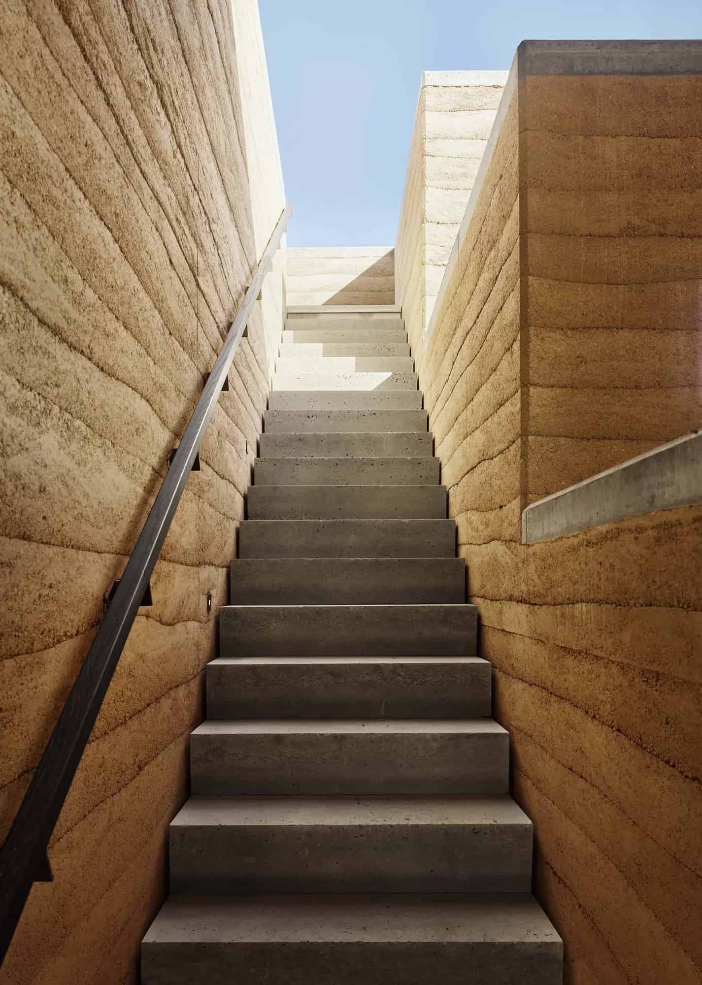 rammed earth ranch house exterior staircase