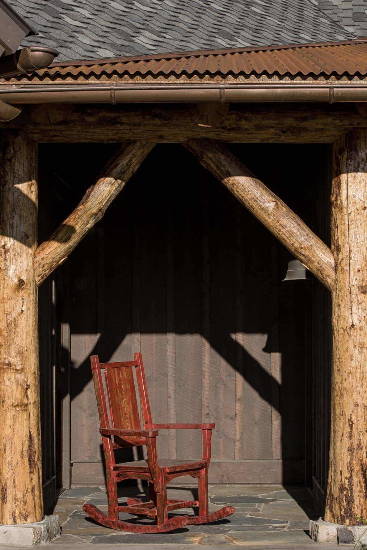 rustic mountain house front porch with a rocking chair