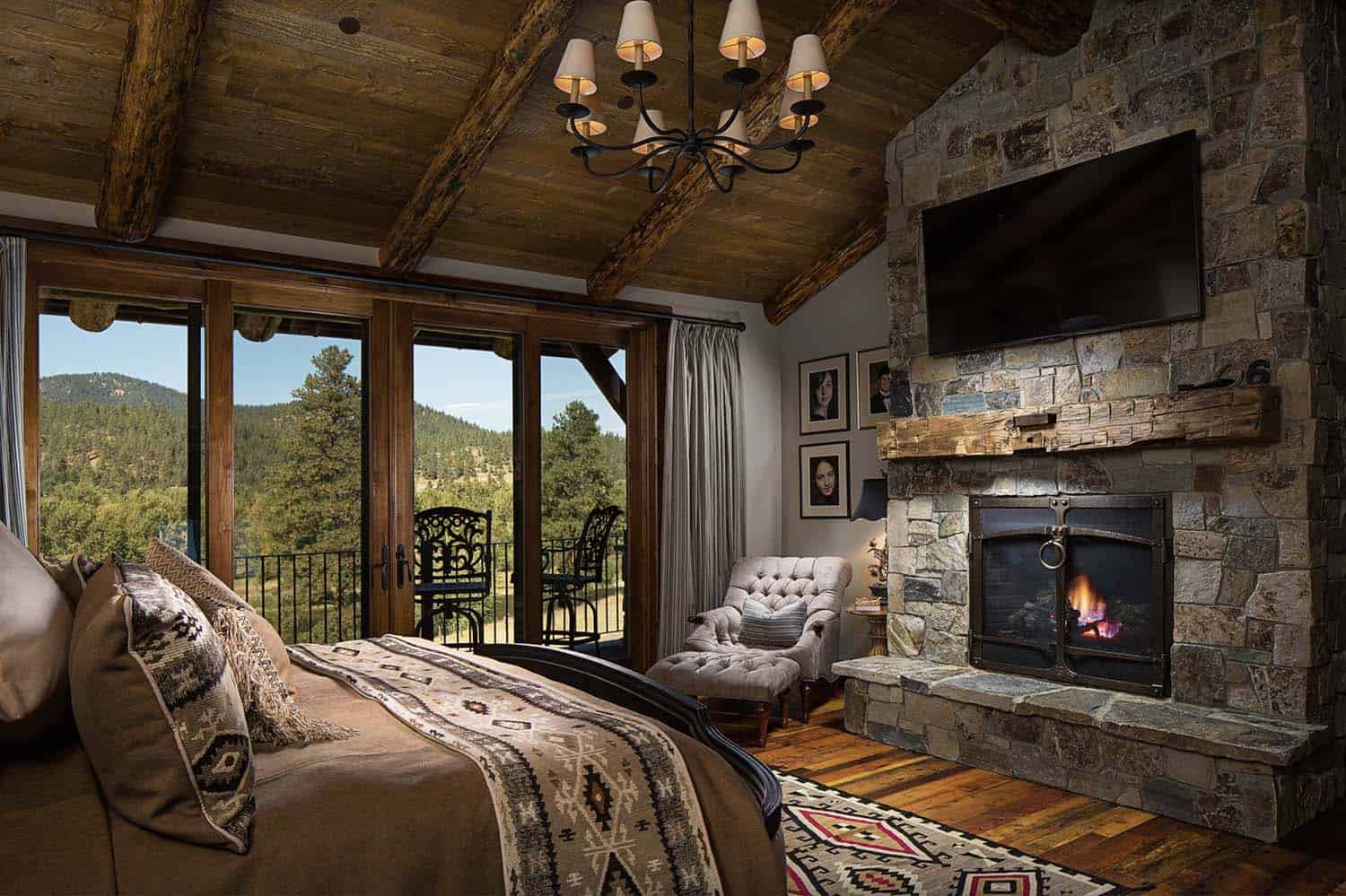 rustic bedroom with a stone fireplace