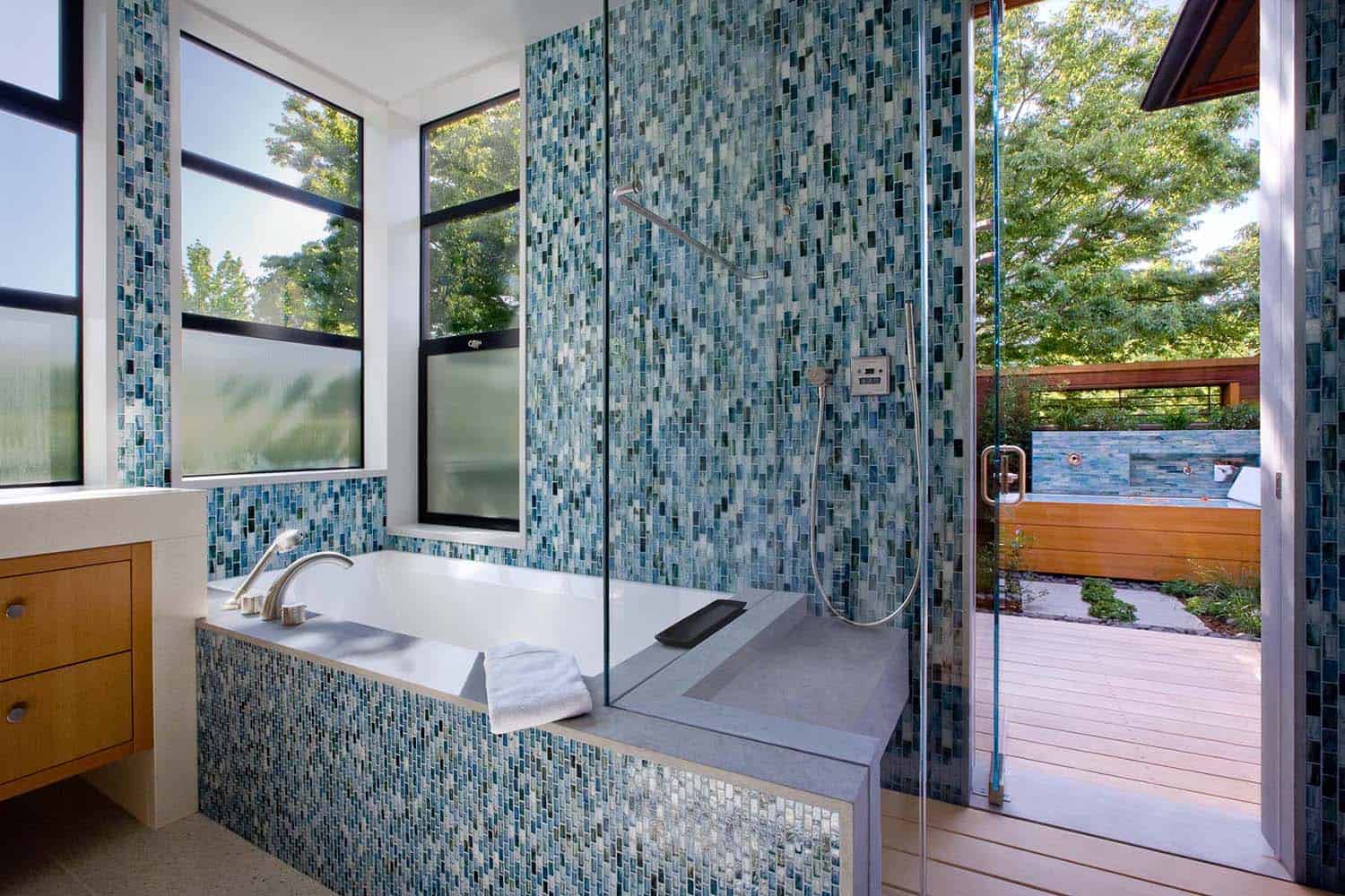 walk through the shower to an outdoor deck with an outdoor shower and tub