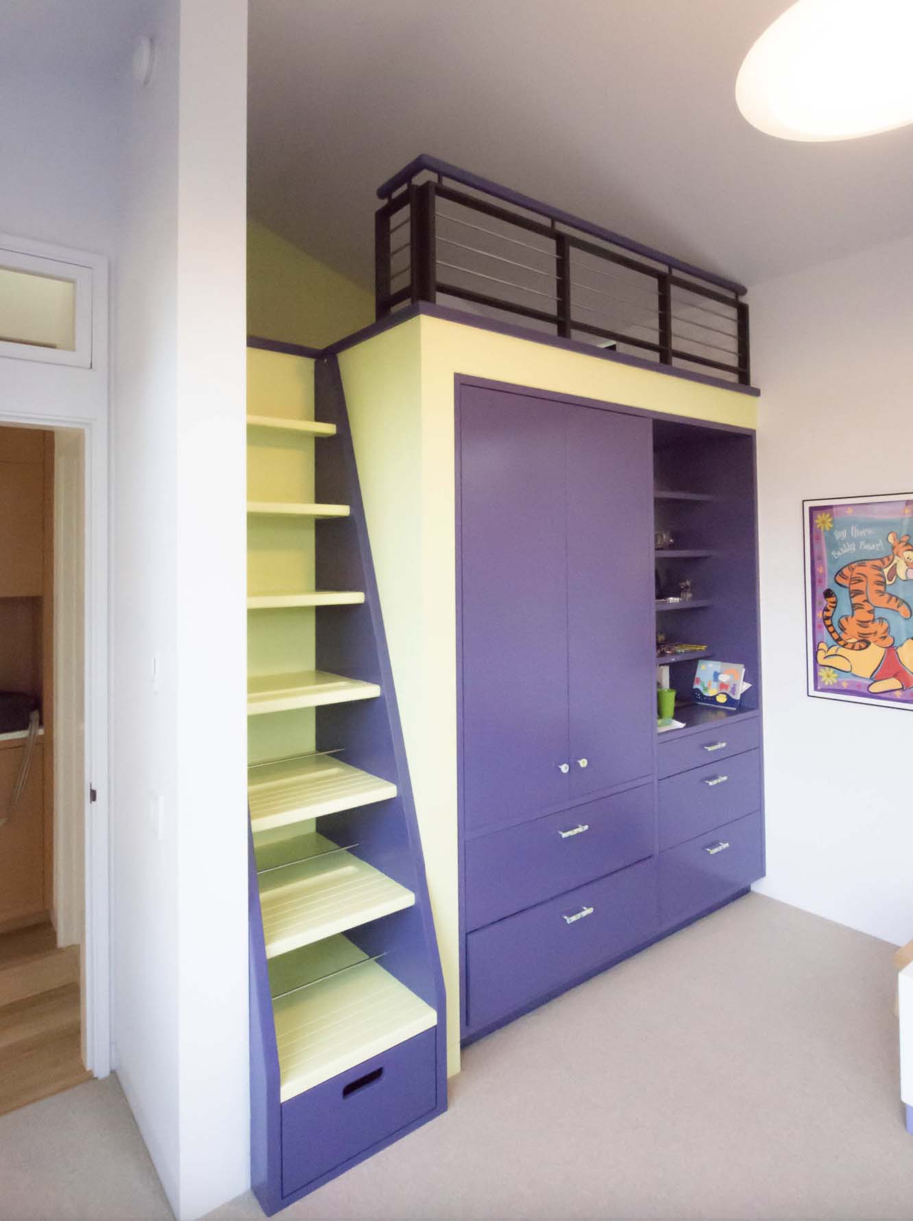 loft access ladder/bookcase adjacent to built-in storage, kid's bedroom
