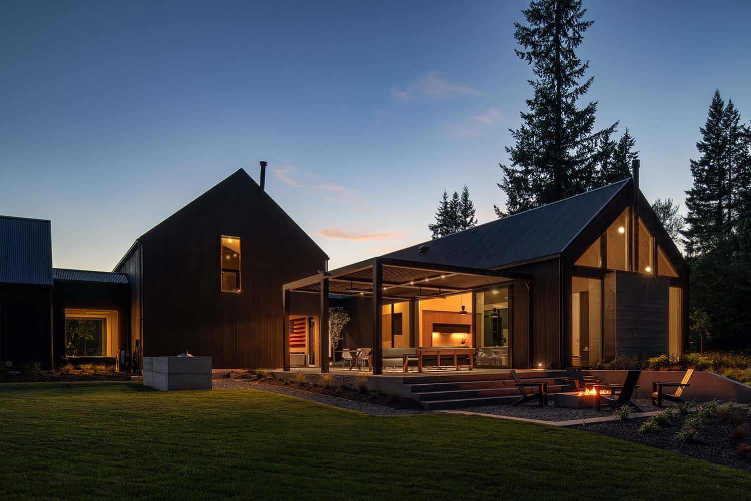 contemporary home exterior with black wood siding at dusk
