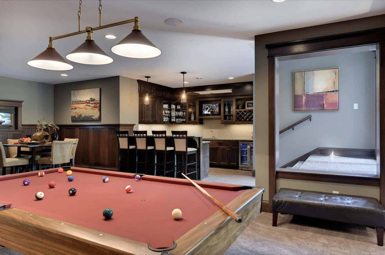 traditional style pool table with a view to the home bar
