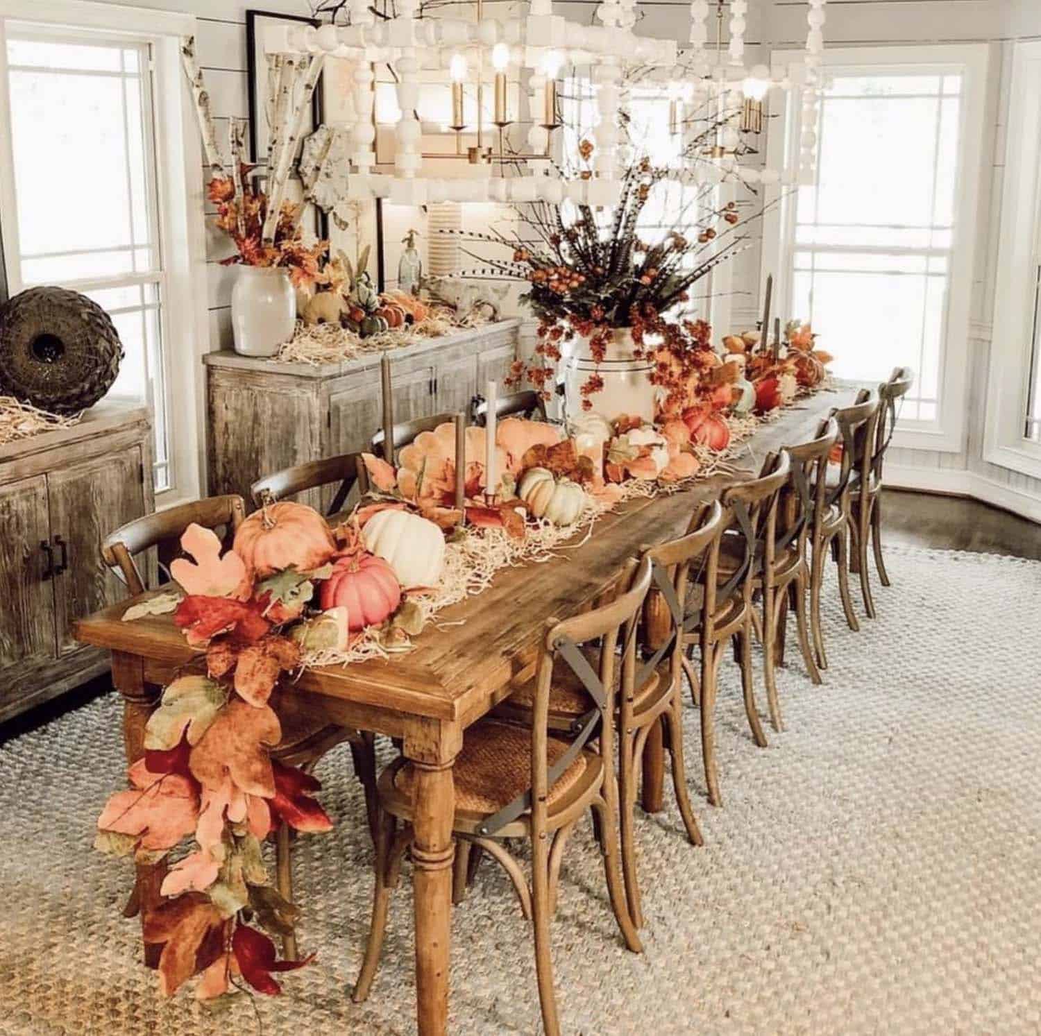 farmhouse style dining room with a leaf garland and pumpkins