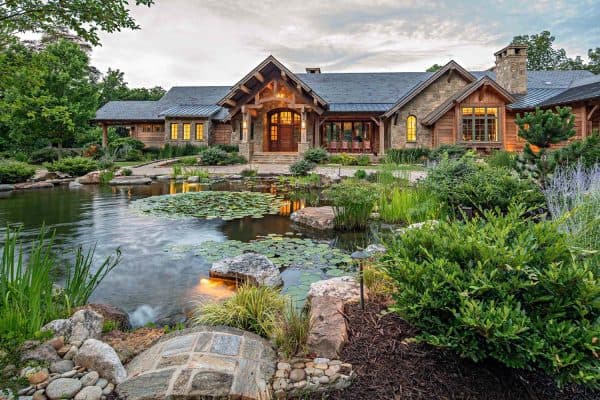 rustic lake house exterior with a large pond