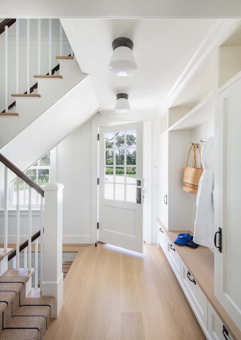 coastal style home entry with a staircase
