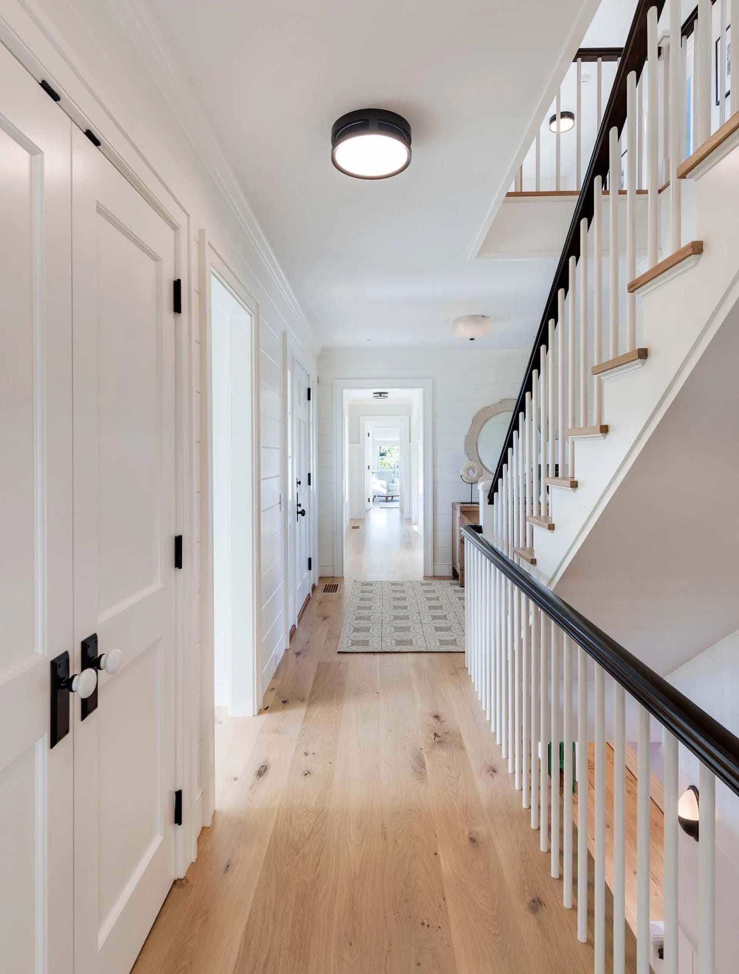 coastal style hallway with a staircase