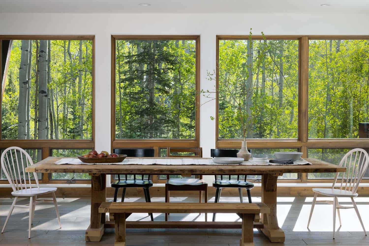 contemporary mountain home dining room with a view of the forest