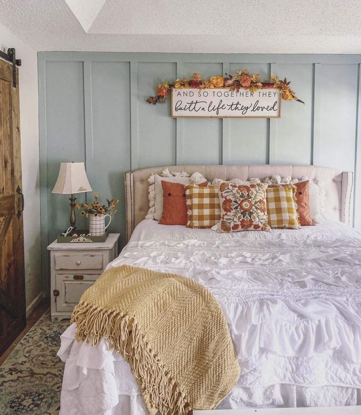 rustic bedroom with fall decor and a sky blue accent wall 