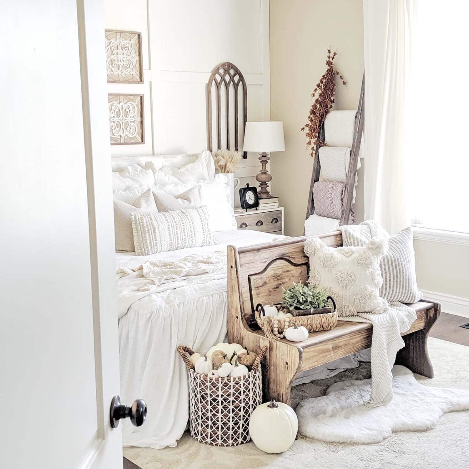 neutral fall bedroom scheme with pumpkins in a basket