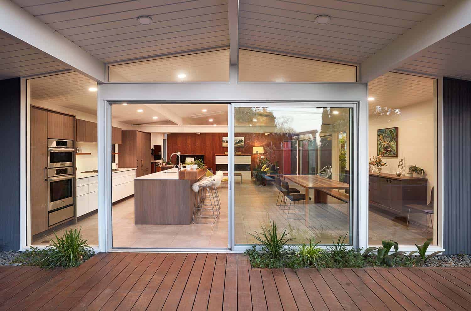 Eichler home exterior with sliding glass doors to the backyard patio