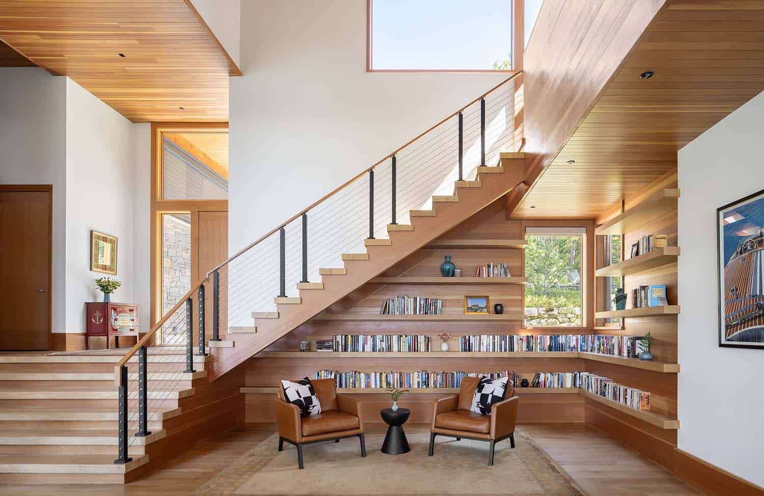 modern home library with a wrap around staircase