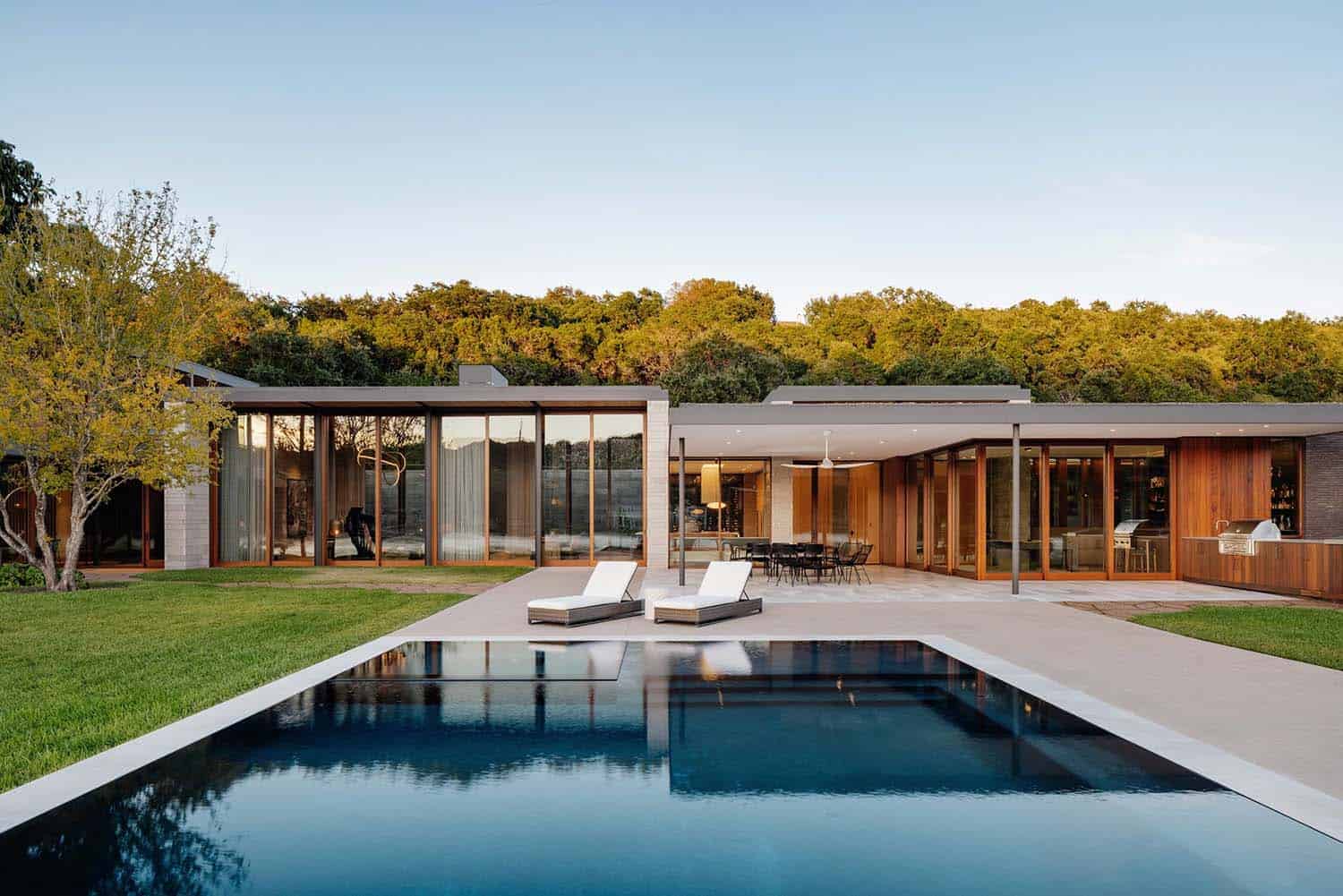 modern lake house exterior with a backyard pool