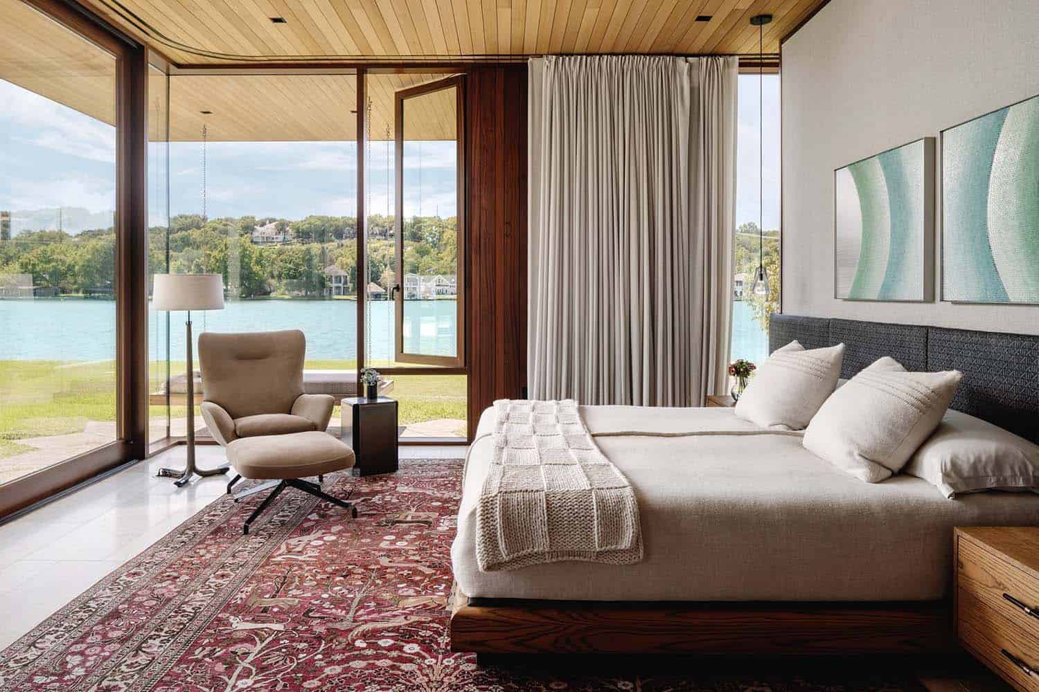 modern bedroom with large windows and view of Lake Austin