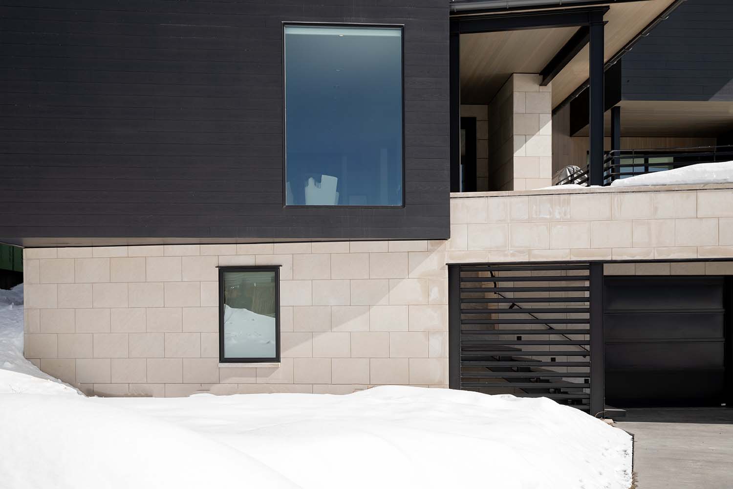 modern mountain lodge exterior with snow