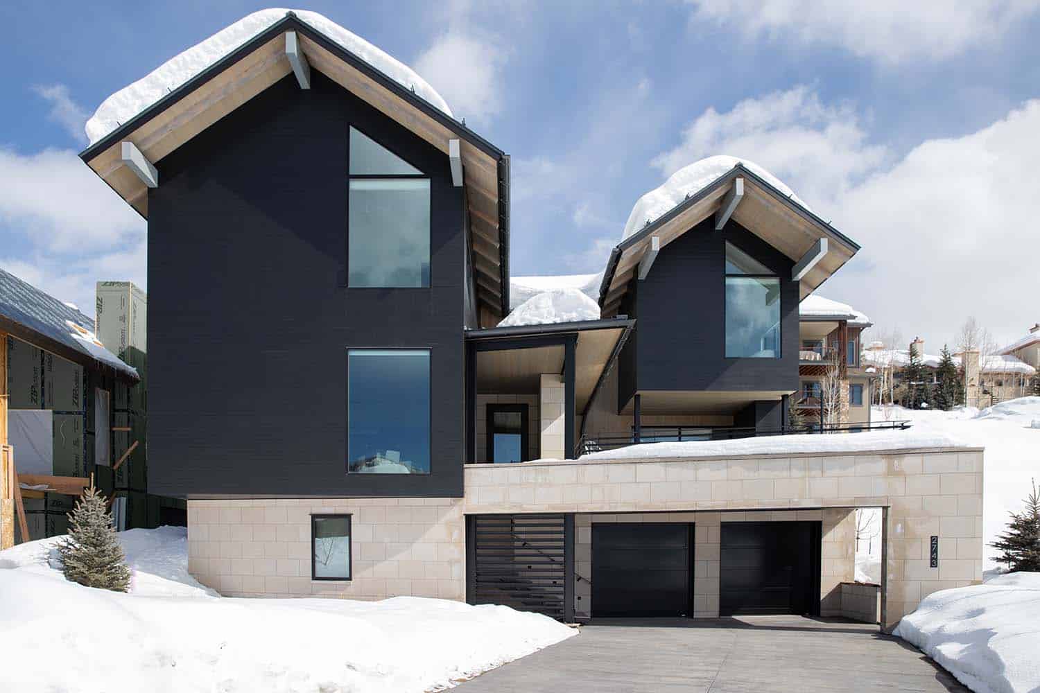 modern mountain lodge exterior with snow