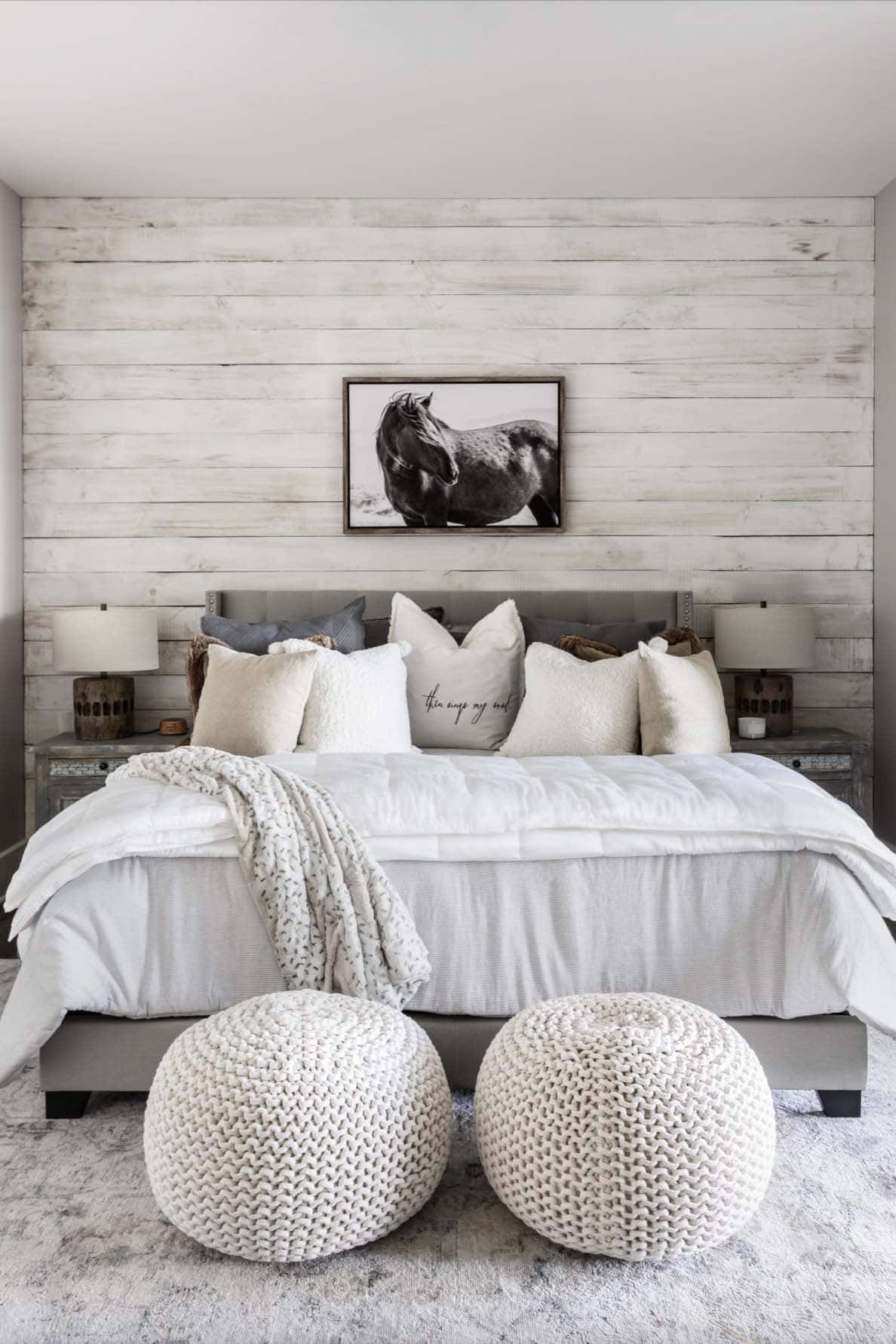 rustic guest bedroom with a whitewashed wood wall