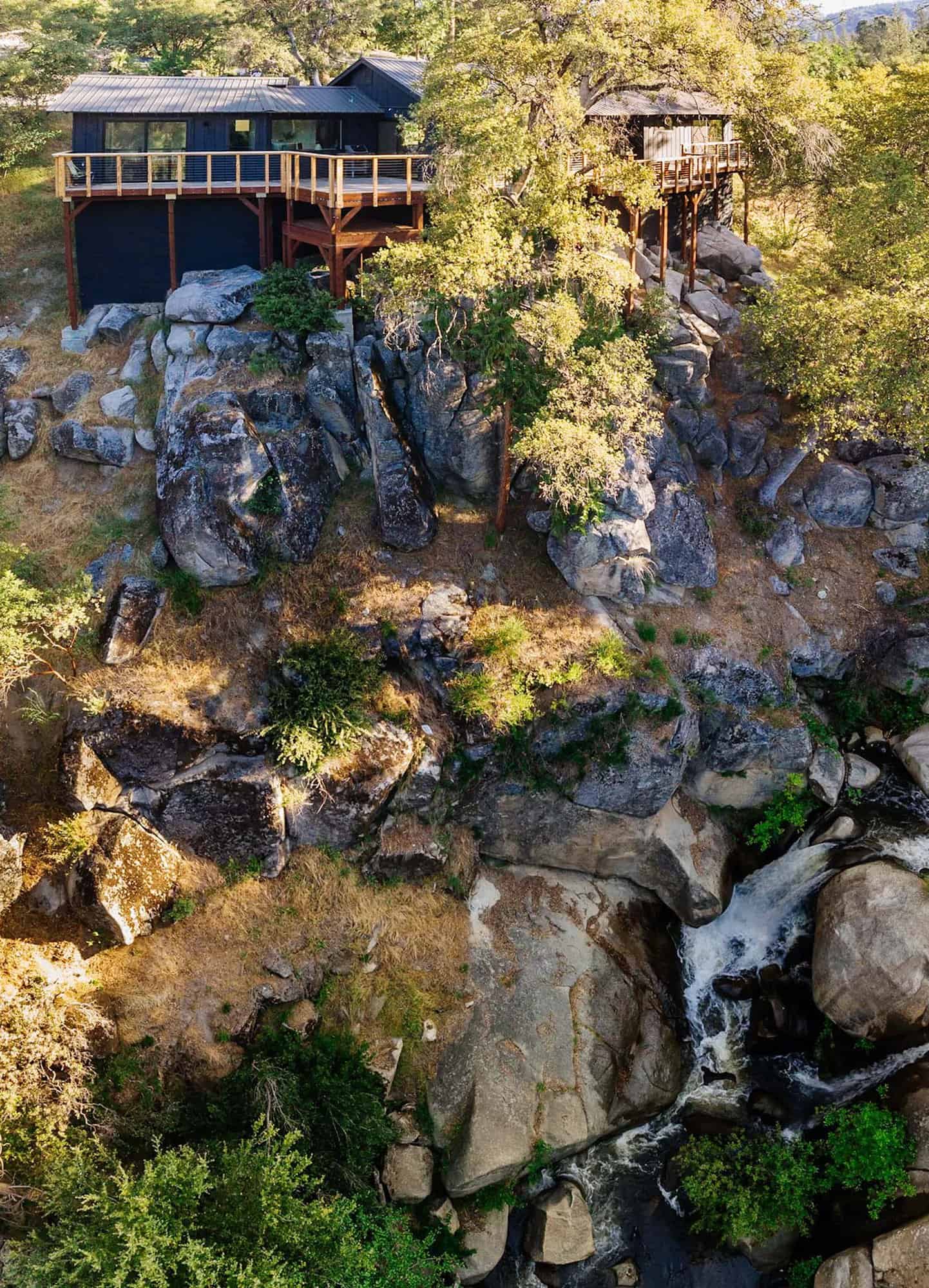 stick framed cabin exterior with a waterfall view