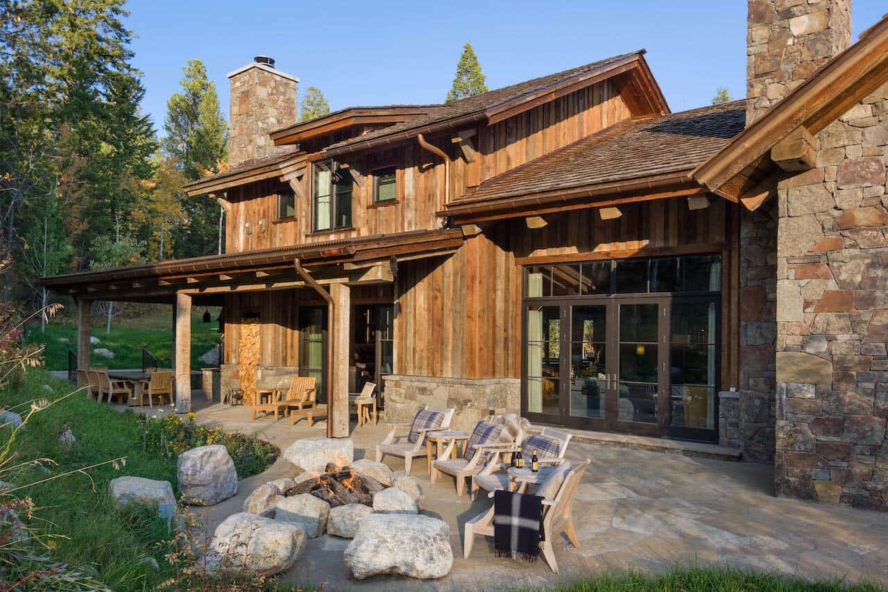 rustic mountain home exterior with a fire pit and chairs