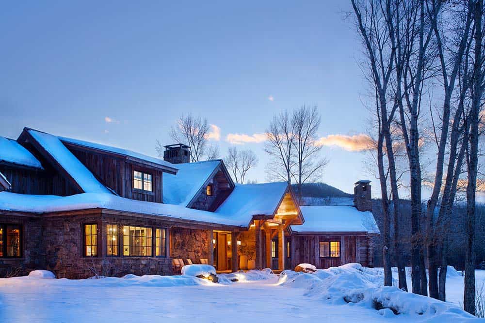 rustic modern mountain home exterior at dusk