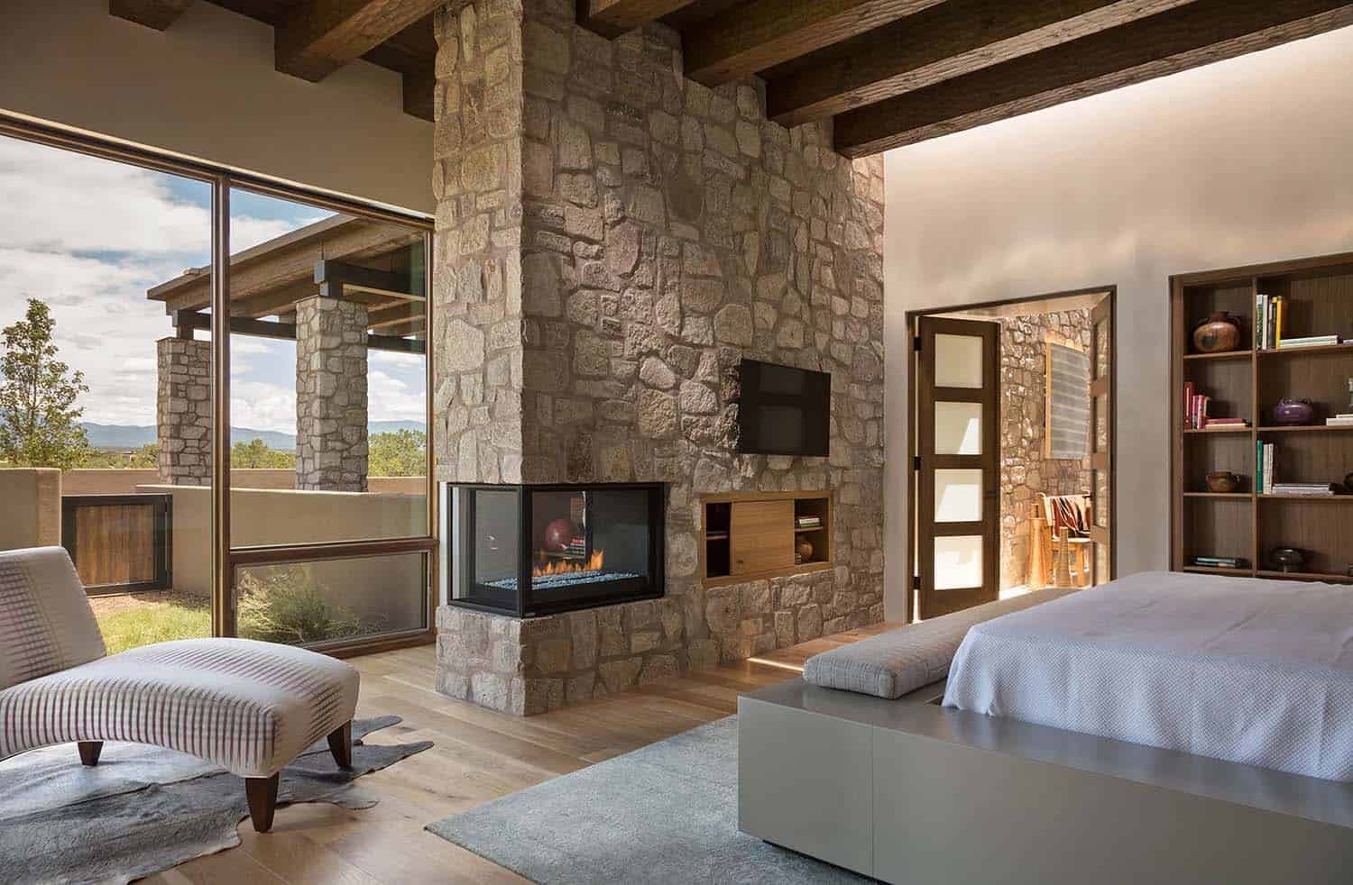 Santa Fe style bedroom with a fireplace