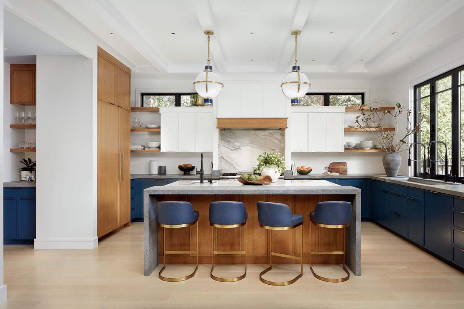 transitional kitchen with a waterfall island countertop