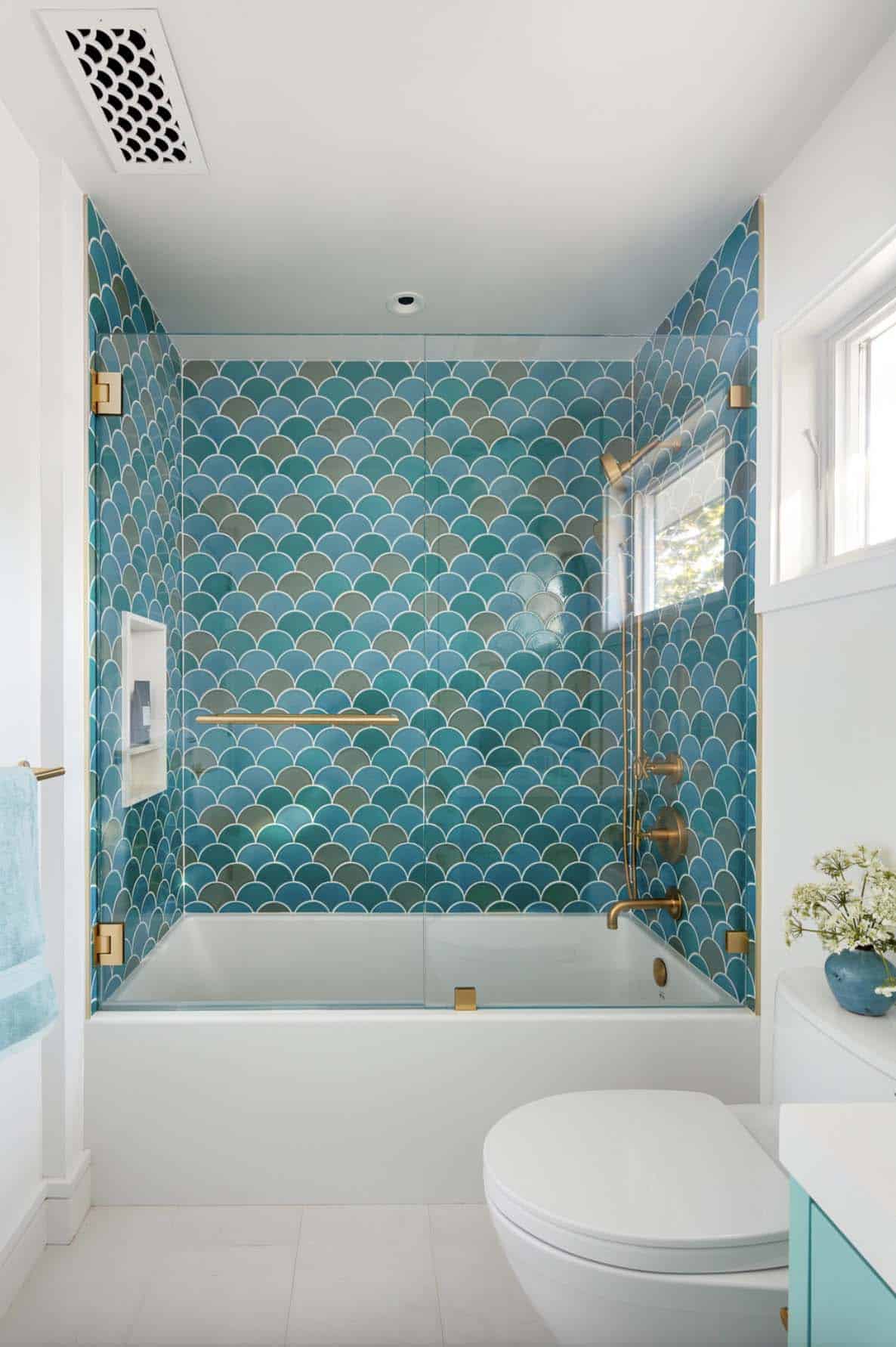 transitional bathroom with blue wall tile in the tub and shower combo