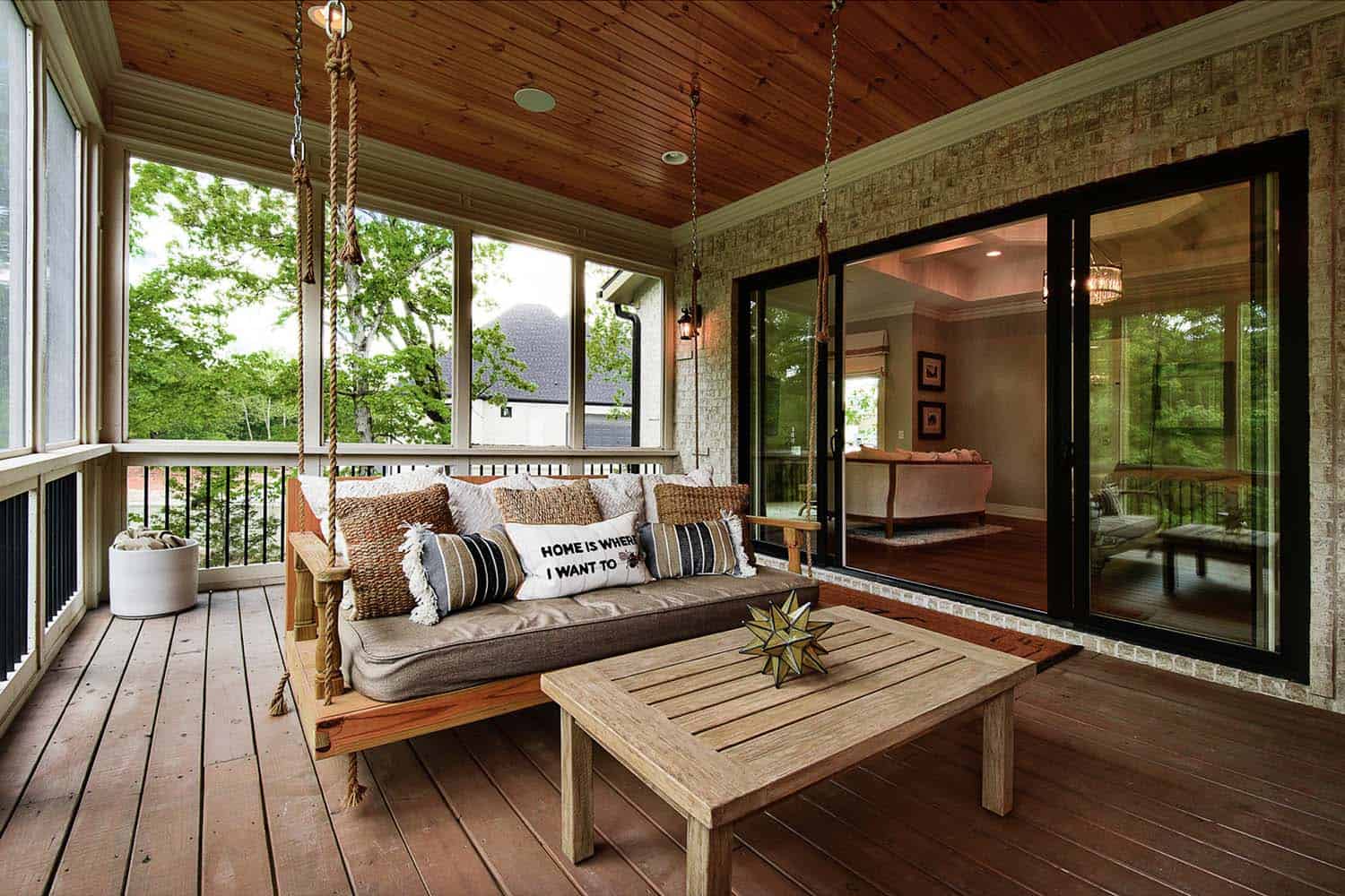 transitional style covered patio with a hanging swing