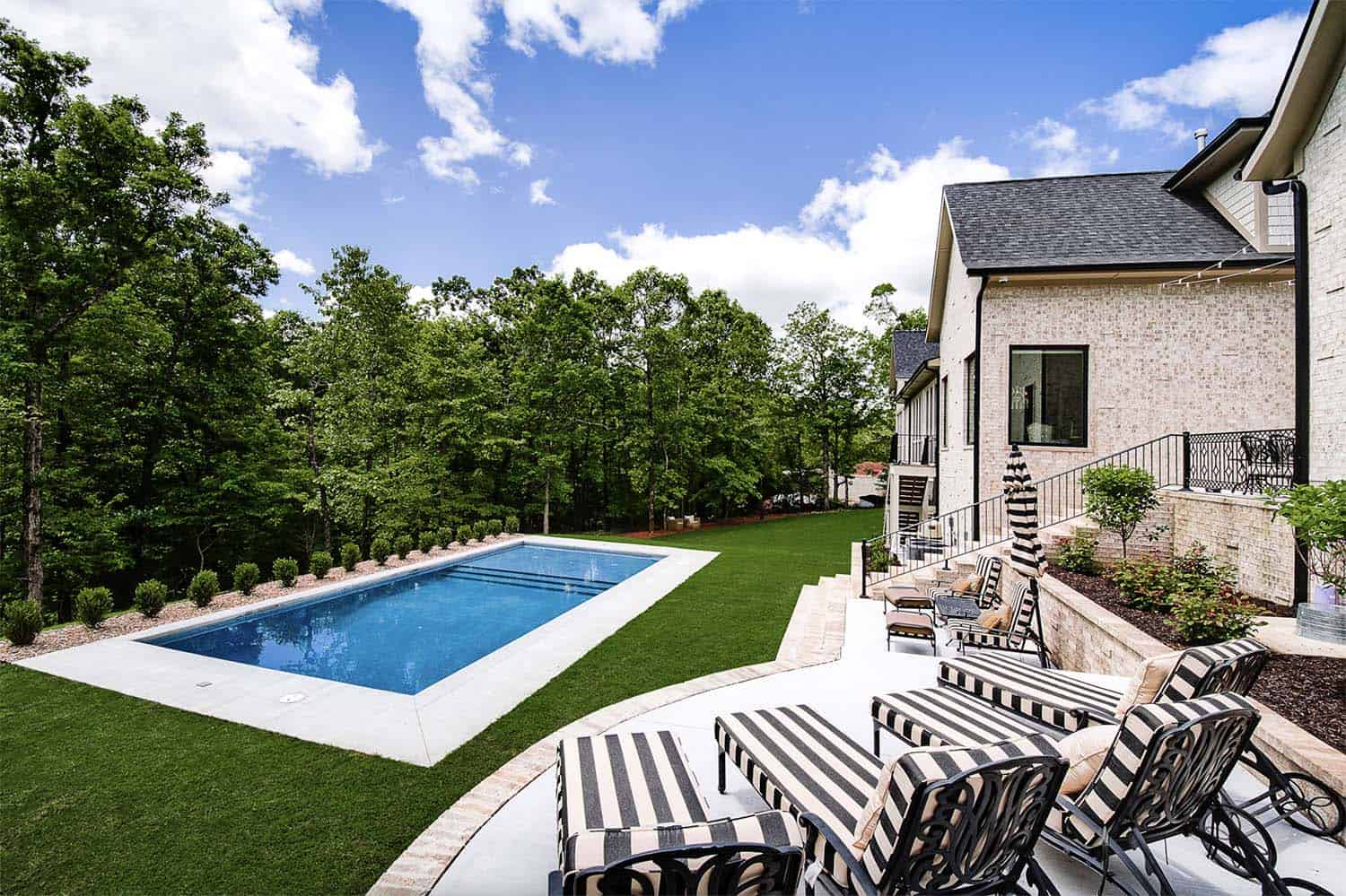 transitional style home exterior with a pool in the backyard